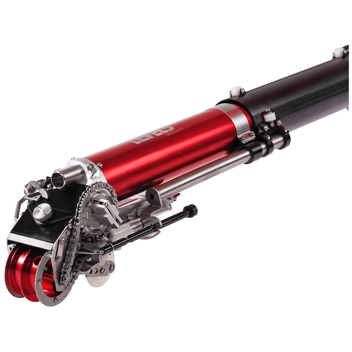 Close-up of Level 5 Automatic Taper head with a red and black billet aluminum body, steel components, and white creaser wheel, left side
