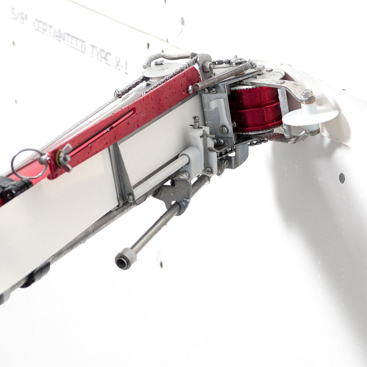 Level 5 Automatic Taper with a red and black billet aluminum body, steel components, white creaser wheel, and black tape roll assembly, left side